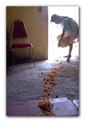 woman leaving marigolds for Dias De Los Muertos